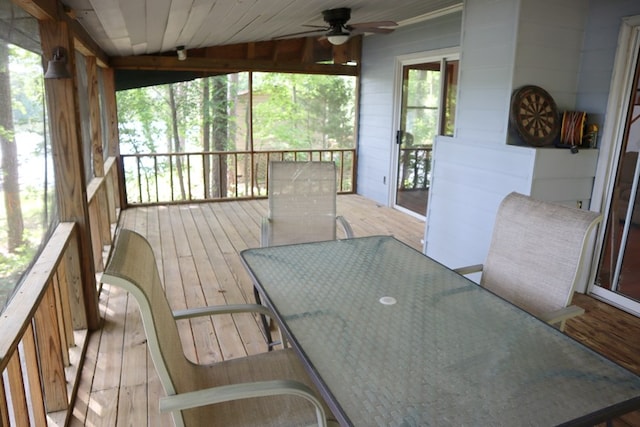 sunroom featuring outdoor dining space, a ceiling fan, and vaulted ceiling