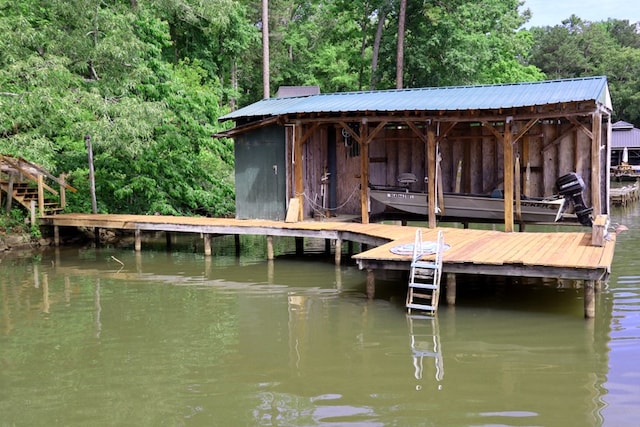 dock area with a water view and a wooded view