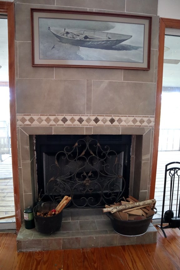 detailed view of a fireplace and wood finished floors