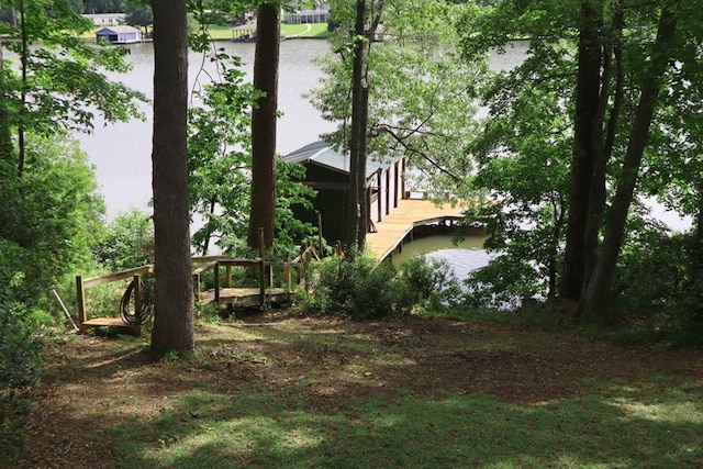 view of side of home with a boat dock and a water view