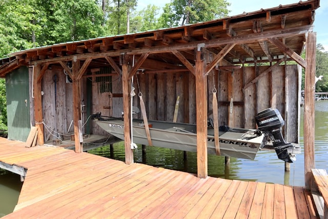 dock featuring boat lift and a water view