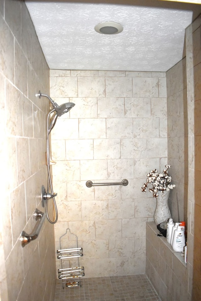 bathroom with tiled shower