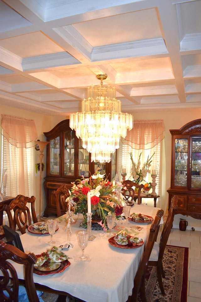 dining room with beamed ceiling, tile patterned floors, coffered ceiling, and a chandelier