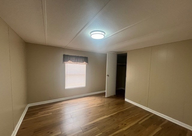 unfurnished room featuring dark wood-type flooring