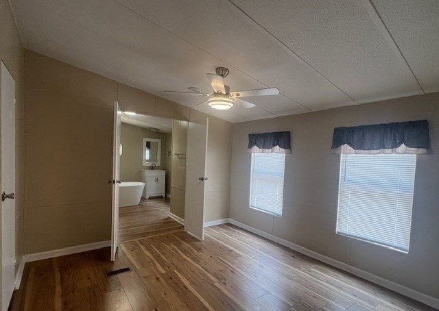 unfurnished bedroom with hardwood / wood-style floors and ceiling fan