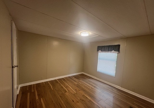 unfurnished room with wood-type flooring