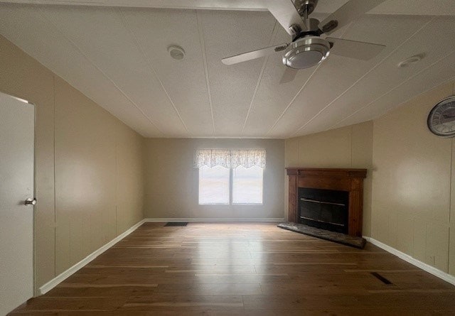 unfurnished living room with dark wood-type flooring and ceiling fan