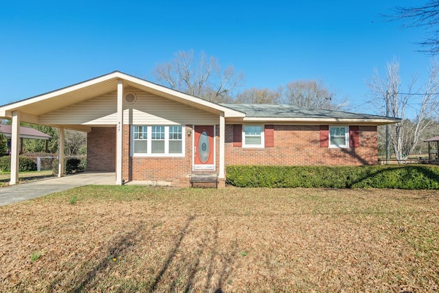 ranch-style house featuring a carport and a front yard