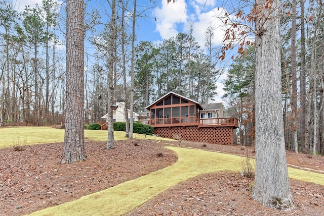 view of yard featuring a deck and a sunroom