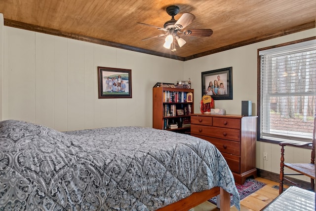 bedroom with wood ceiling, ornamental molding, ceiling fan, and hardwood / wood-style flooring