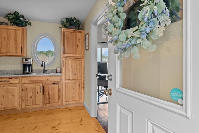 interior space featuring sink and light hardwood / wood-style flooring