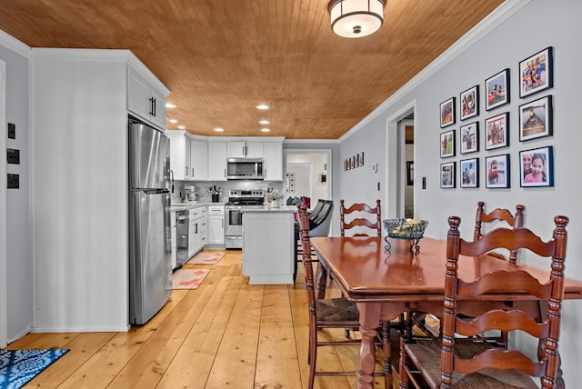 dining space featuring crown molding, light hardwood / wood-style floors, and wooden ceiling