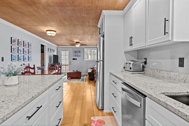 kitchen featuring white cabinetry, ornamental molding, stainless steel appliances, and light stone countertops