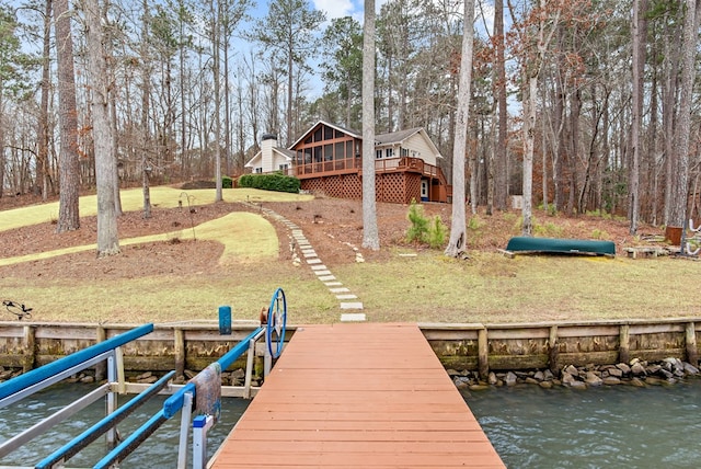 dock area with a deck with water view and a lawn