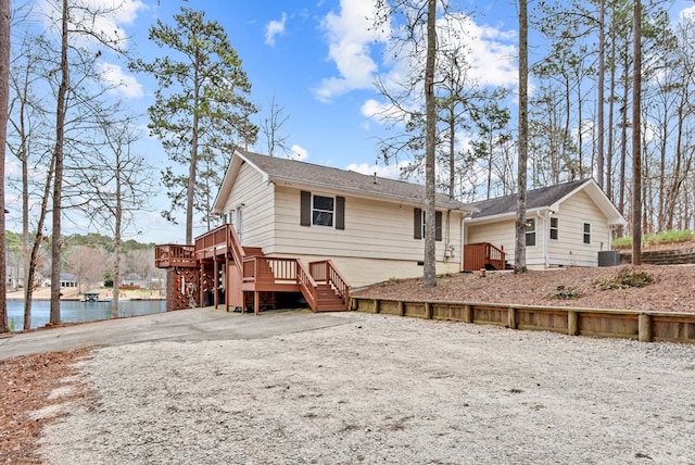 rear view of property featuring a deck with water view