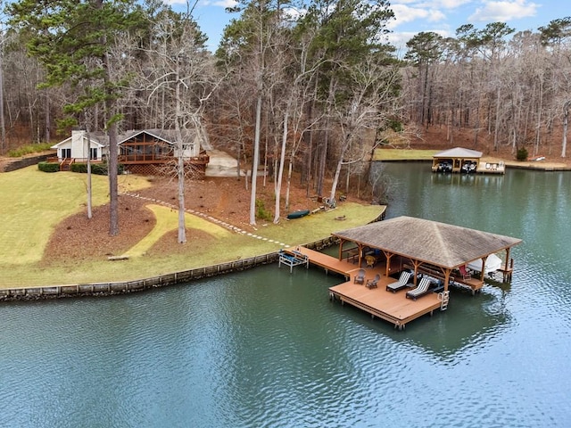 dock area with a water view and a yard