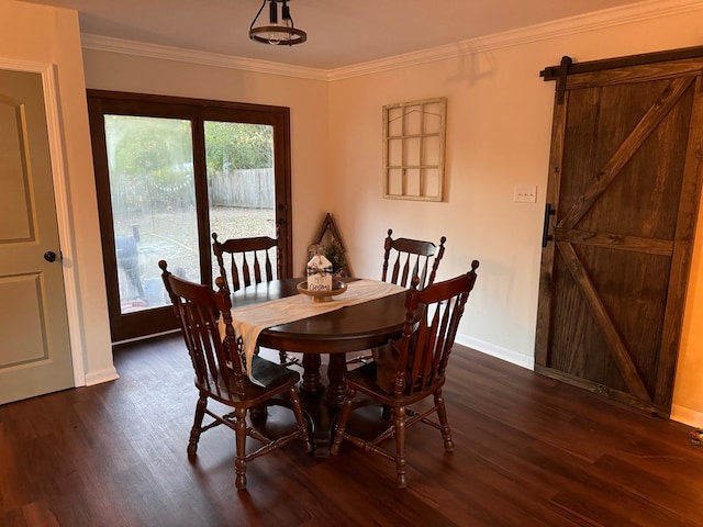 dining room with a barn door, dark hardwood / wood-style floors, and ornamental molding