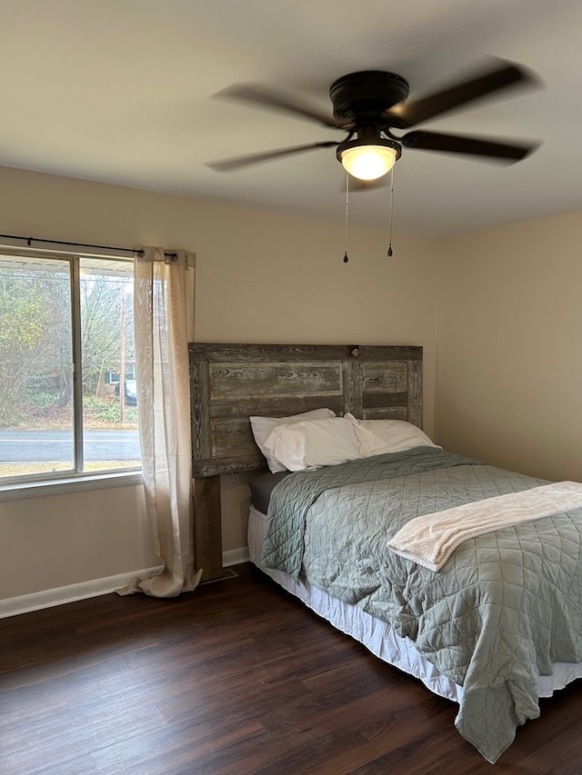 bedroom with dark wood-type flooring and ceiling fan