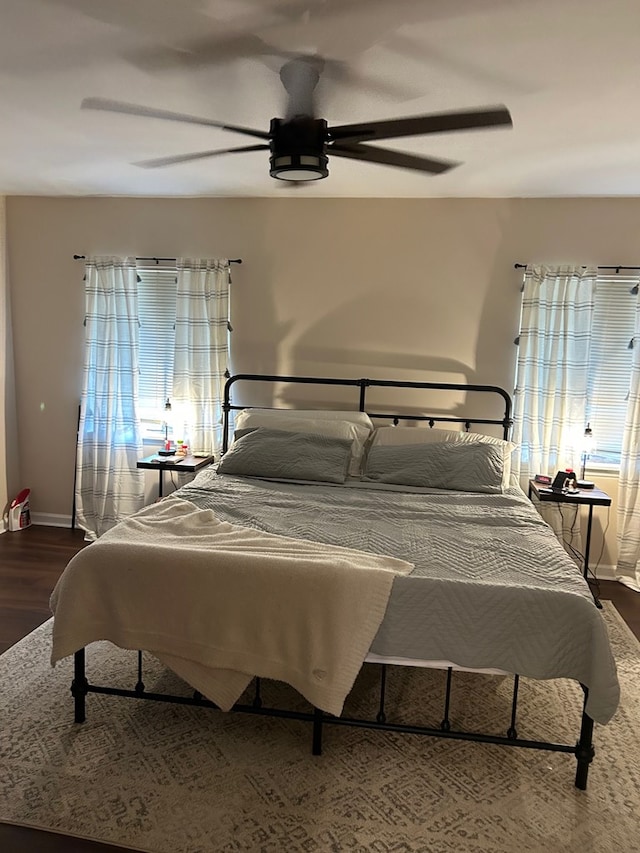 bedroom with ceiling fan and hardwood / wood-style flooring