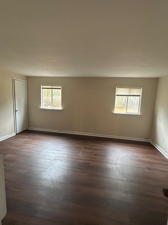 spare room with dark hardwood / wood-style flooring