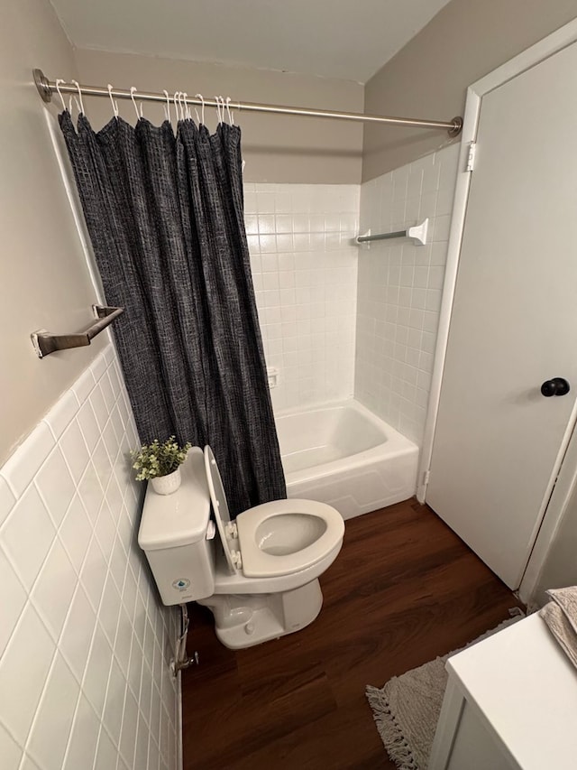 bathroom featuring toilet, hardwood / wood-style flooring, and shower / bathtub combination with curtain