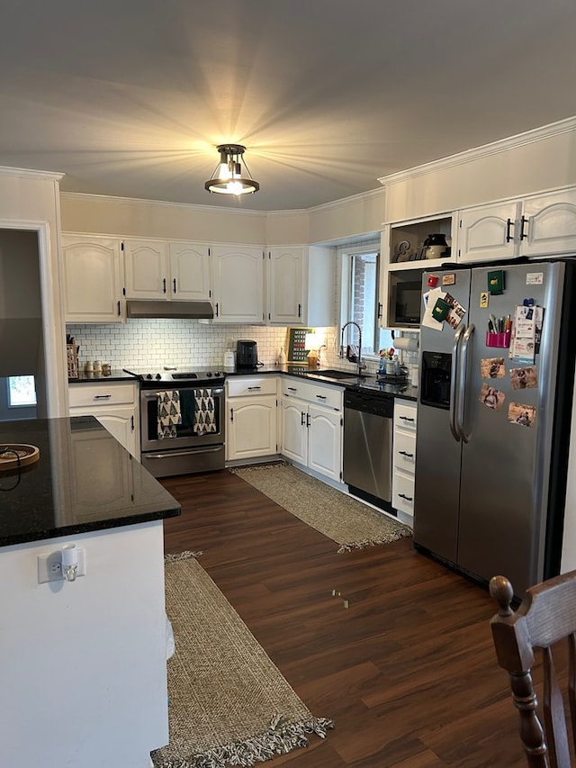 kitchen with white cabinets, appliances with stainless steel finishes, sink, and dark hardwood / wood-style floors