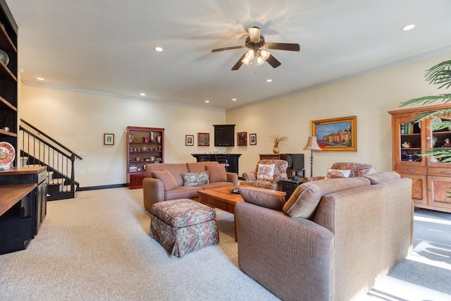 living room with stairs, ornamental molding, recessed lighting, and light carpet