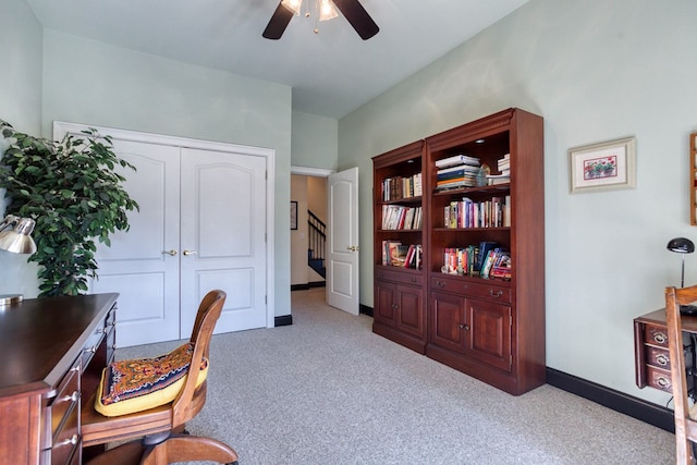 carpeted office with a ceiling fan and baseboards