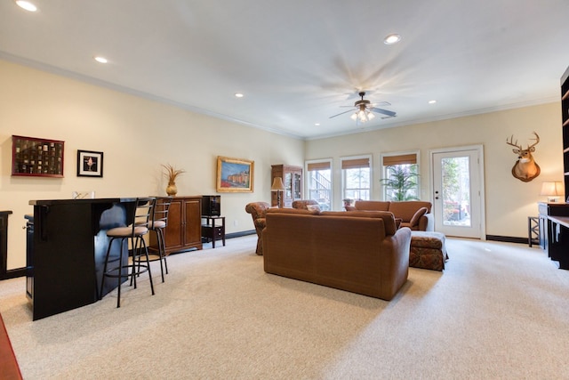 living room with carpet flooring, baseboards, and ornamental molding