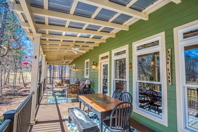 deck featuring outdoor dining space and a ceiling fan