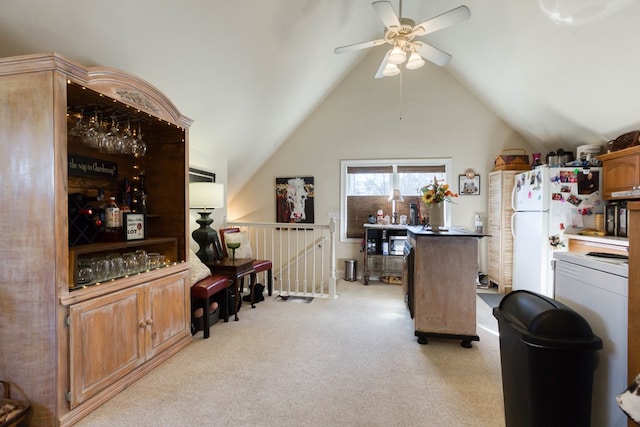 kitchen with light carpet, lofted ceiling, ceiling fan, and freestanding refrigerator