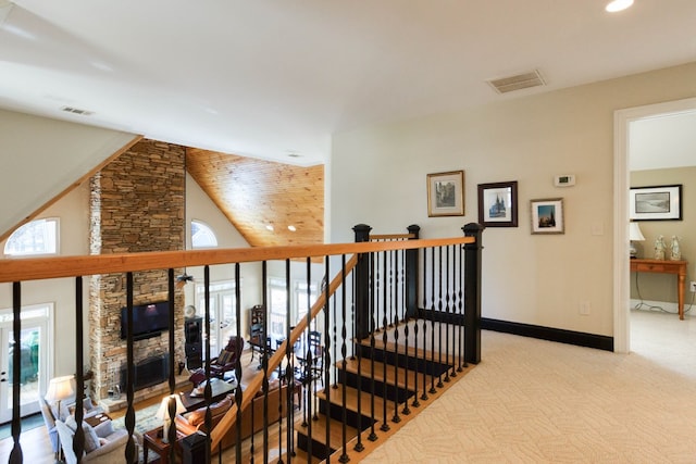 stairway featuring visible vents, plenty of natural light, carpet flooring, and baseboards