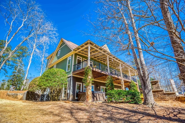 view of front of property featuring a balcony and board and batten siding