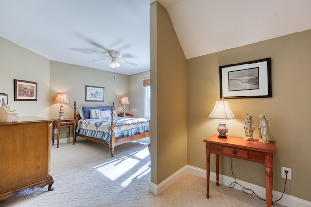 bedroom featuring light carpet, a ceiling fan, and baseboards