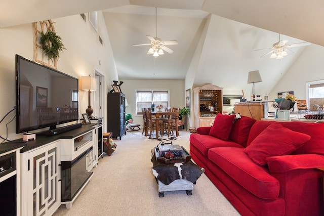 carpeted living area featuring a sink, high vaulted ceiling, and a ceiling fan