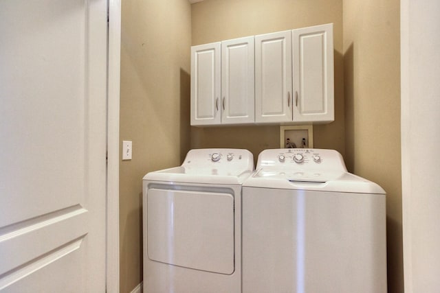 laundry room with washer and dryer and cabinet space