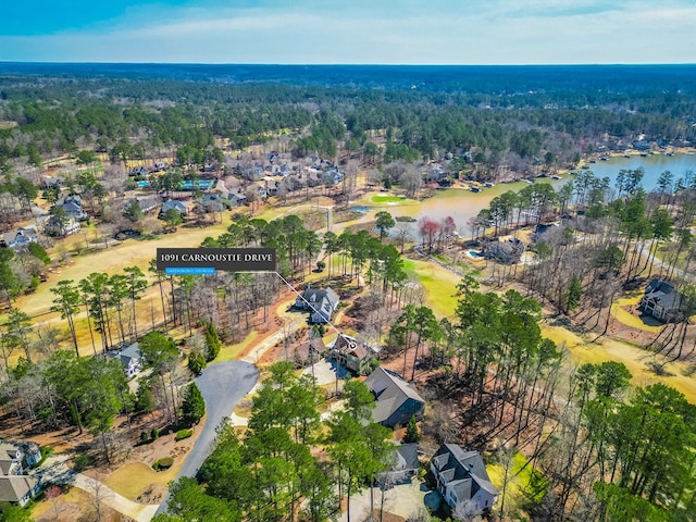 bird's eye view with a wooded view and a water view