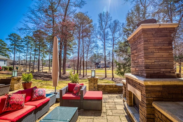 view of patio featuring an outdoor living space with a fireplace