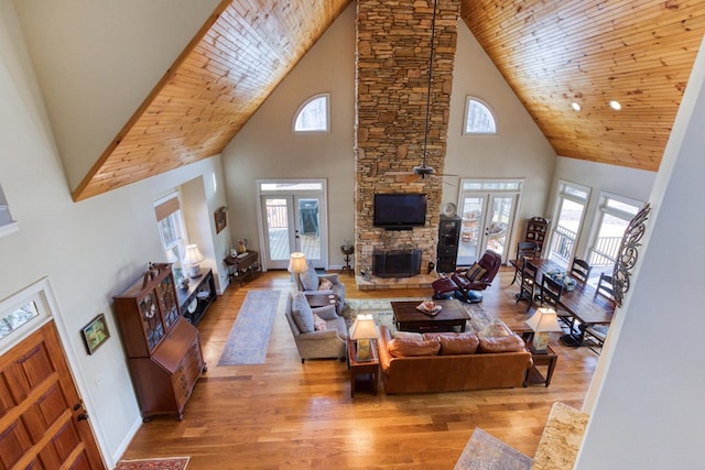 living room featuring french doors, a fireplace, and wood finished floors