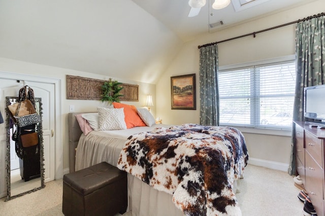 bedroom with visible vents, baseboards, vaulted ceiling, light carpet, and a ceiling fan