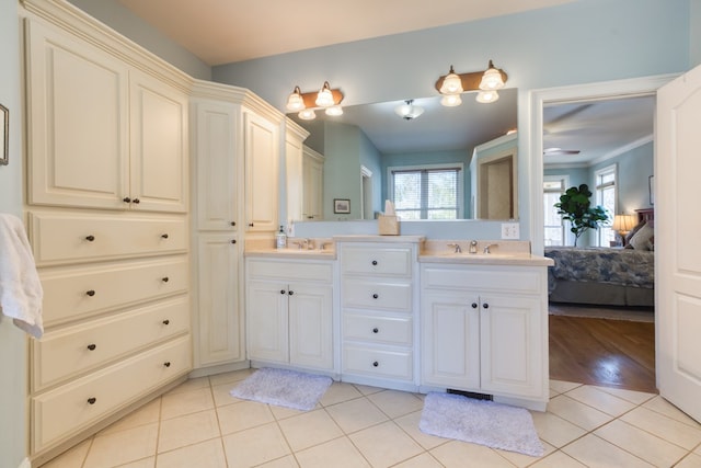 ensuite bathroom featuring tile patterned floors, double vanity, ensuite bathroom, and a sink