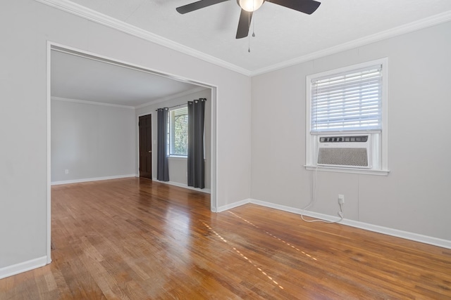 empty room featuring hardwood / wood-style flooring, cooling unit, ornamental molding, and ceiling fan