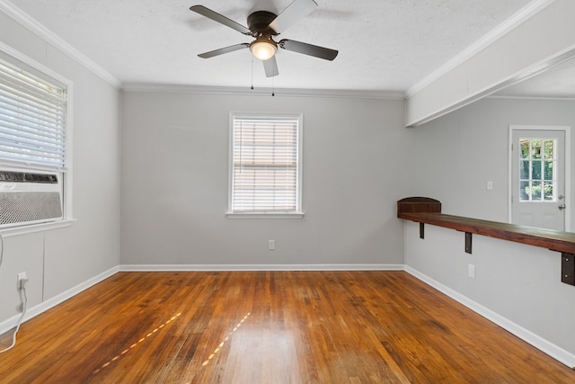 unfurnished room with ceiling fan, cooling unit, dark wood-type flooring, and ornamental molding