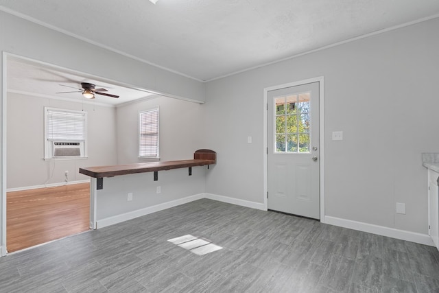 interior space featuring cooling unit, crown molding, ceiling fan, dark hardwood / wood-style floors, and a textured ceiling