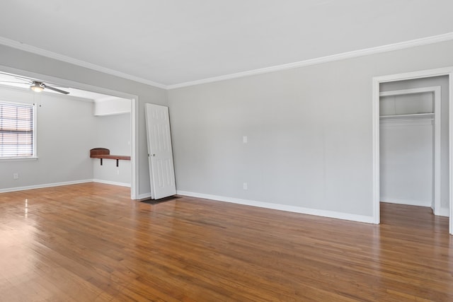 interior space with hardwood / wood-style floors, ceiling fan, and ornamental molding