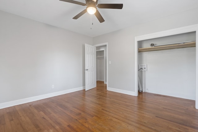 unfurnished bedroom featuring ceiling fan and dark wood-type flooring