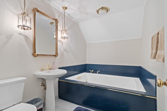 220 Oconnor Dr, Milledgeville, GA 31061 - bathroom featuring a bath, vaulted ceiling, and toilet