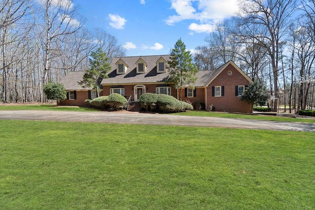 220 Oconnor Dr, Milledgeville, GA 31061 - cape cod-style house with asphalt driveway, a front lawn, and brick siding