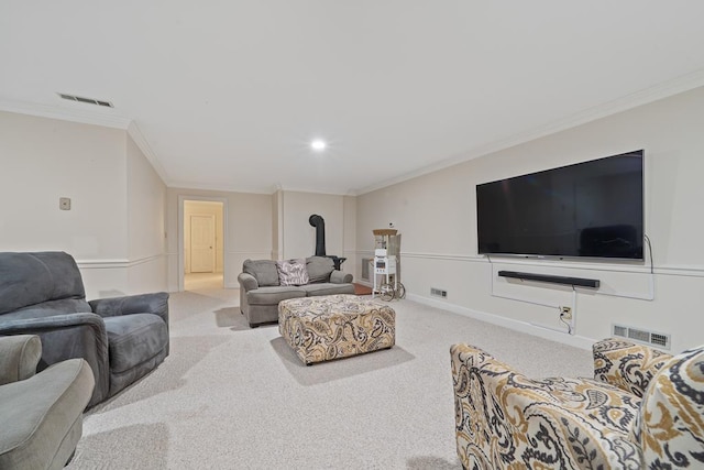 220 Oconnor Dr, Milledgeville, GA 31061 - carpeted living room featuring a wood stove, ornamental molding, and recessed lighting