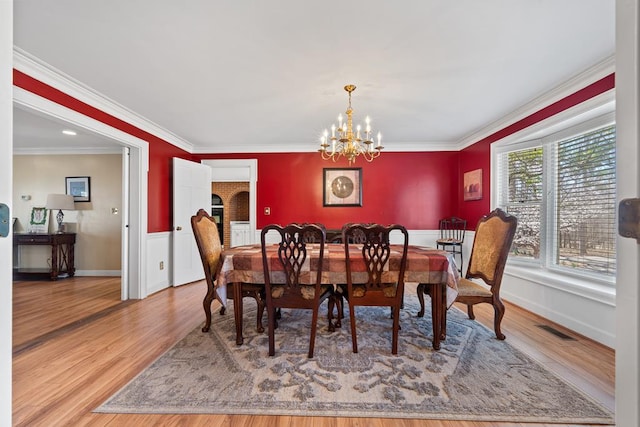 220 Oconnor Dr, Milledgeville, GA 31061 - dining room with wood finished floors, a chandelier, ornamental molding, and baseboards